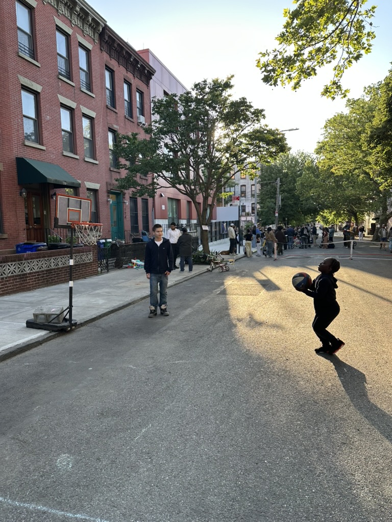 Children playing basketball in the street during the Spring 2026 Block Party